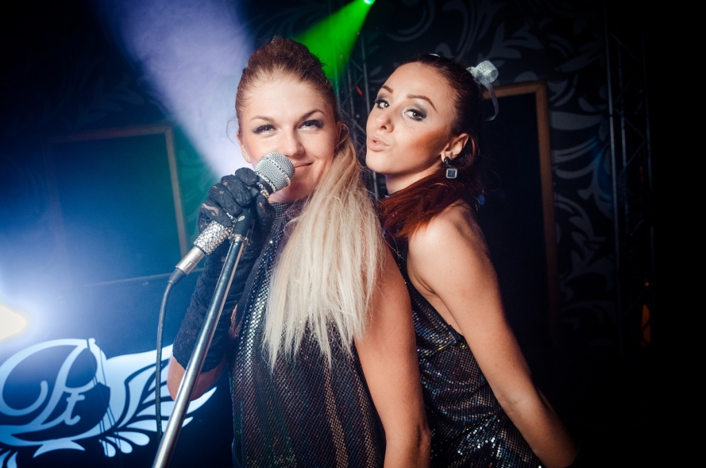 Two girls with microphone. The club