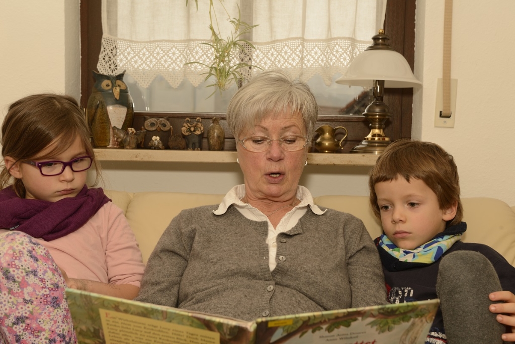 Grandma reading out to Kids