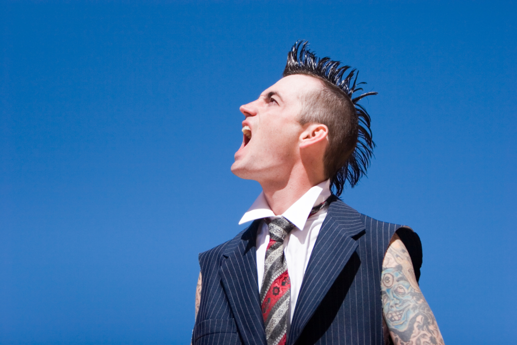 Man with mohawk style haircut and alternative fashion outfit
