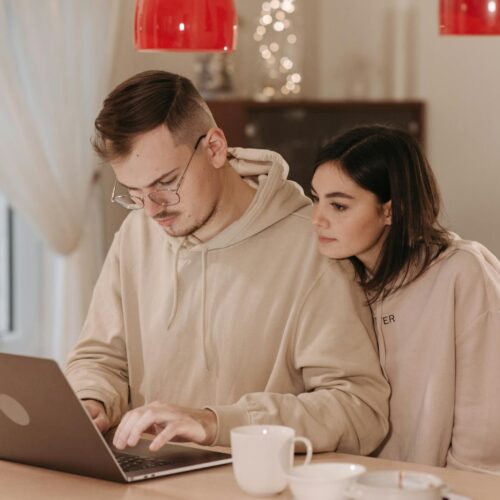 A Couple Using a Laptop at Home