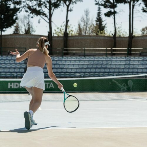 Woman Playing Tennis on a Court